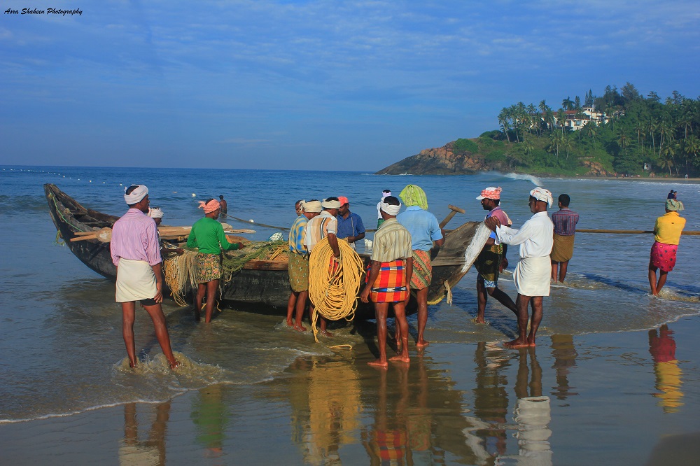 fishermen taking boat out to sea.
Kovalam-Kerala-tourism