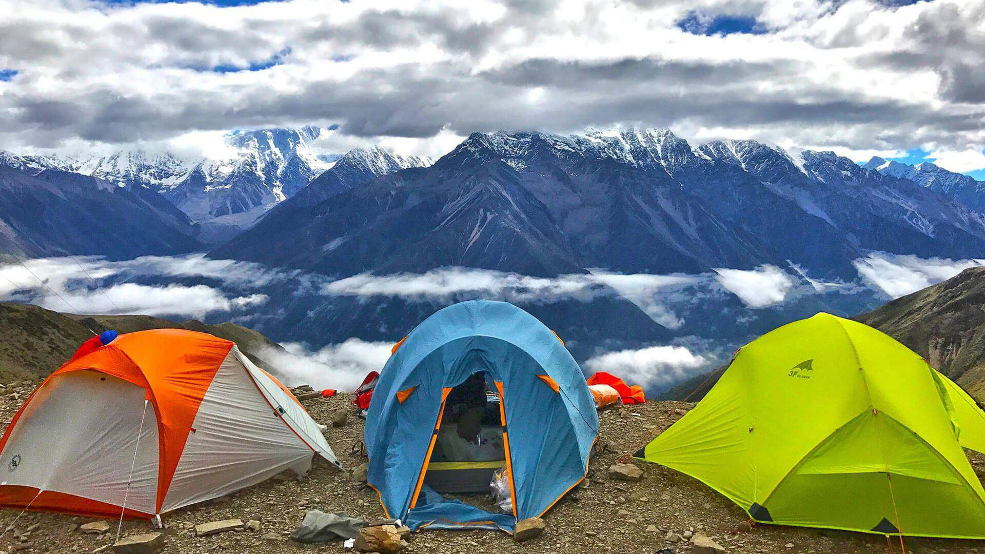tents put up against a mountainous backdrop
