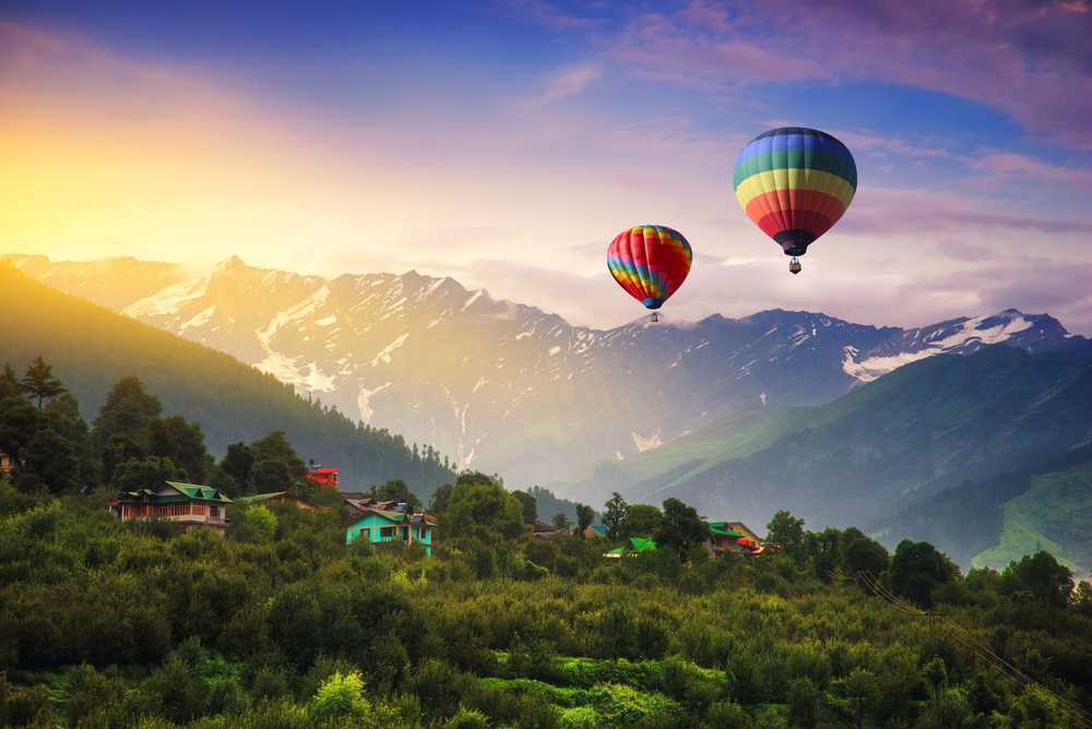 hot-air balloons in air against a scenic backdrop of mountains and forest
Manali-Tourism-Packages